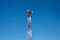 Cell phone antenna, transmitter. Telecom radio mobile antenna against blue sky Royalty Free Stock Photo