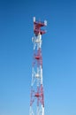 Cell phone antenna, transmitter. Telecom radio mobile antenna against blue sky Royalty Free Stock Photo