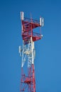 Cell phone antenna, transmitter. Telecom radio mobile antenna against blue sky Royalty Free Stock Photo