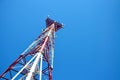 Cell phone antenna, transmitter. Telecom radio mobile antenna against blue sky Royalty Free Stock Photo