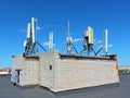 Cell phone antenna, transmitter. Telecom radio mobile antenna against blue sky Royalty Free Stock Photo