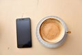 Cell phone and coffee cup on a vintage table Royalty Free Stock Photo