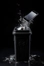 A cell phone falls into the trash can. An old broken phone. Generation AI