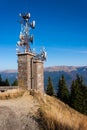 Cell phone relay tower on hill. Mountains seen in the background Royalty Free Stock Photo