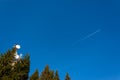 Cell phone relay tower on the mountain between some fir trees. P