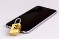 Cell phone security - lock and phone on white Royalty Free Stock Photo