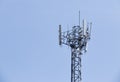 Cell phone tower rises against a blue sky. Royalty Free Stock Photo