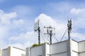 Cell Phone Towers on Resident Building Roof with Blue Sky Royalty Free Stock Photo