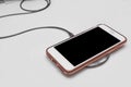 Cell phone on wireless charging pad Royalty Free Stock Photo