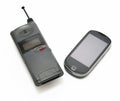 Cell phones evolution. Two different style, model and generation of cell phones on white background. Royalty Free Stock Photo
