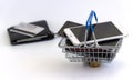 Cell phones in the shopping cart and a wallet with a Bank card. rising prices for cellular communications and gadgets