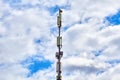Cell tower against a cloudy sky. Base station of cellular operator Royalty Free Stock Photo