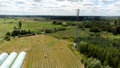 Cell tower, cellular base station aerial shot, drone view cloudy sky, telecommunication tower on a field, rural area, countryside