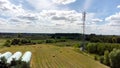 Cell tower, cellular base station aerial shot, drone view cloudy sky, telecommunication tower on a field, rural area, countryside