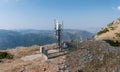 Cell tower. Mobile phone antenna aerial view. Rocky mountain and blue sky Royalty Free Stock Photo