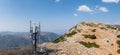 Cell tower. Mobile phone antenna aerial view. Rocky mountain and blue sky Royalty Free Stock Photo