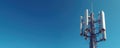 Cell tower with multiple antennas against clear blue sky. Modern telecom infrastructure transmits data wirelessly for global Royalty Free Stock Photo