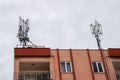 Cell tower on the roof of the building Royalty Free Stock Photo