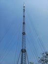 a cell tower standing tall against a blue sky Royalty Free Stock Photo