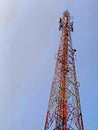 a cell tower standing tall against a blue sky Royalty Free Stock Photo