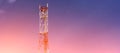 Cell tower on sunset sky background. Technology 5G network. Royalty Free Stock Photo