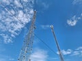 Cell towers against a blue sky. Two metal cell towers on blue background Royalty Free Stock Photo