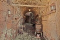 Celleno, Viterbo, Lazio, Italy: underpass in the ancient abandoned village with an old wine press and tools