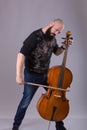 Cellist playing classical music on cello. bearded man fooling around with a musical instrument Royalty Free Stock Photo