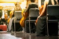 Cello in cellist hands at classical music symphony concert closeup