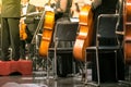 Cello in cellist hands at classical music symphony concert closeup