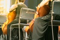 Cello in cellist hands at classical music symphony concert closeup