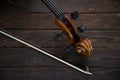 The cello lies on a wooden surface with a bow. Place for text Royalty Free Stock Photo