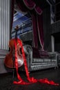 Cello and red ribbon on grey couch
