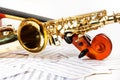 Cello tuning pegs and shiny golden alto saxophone Royalty Free Stock Photo