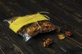 Cellophane bag with dried fruits on dark wooden background