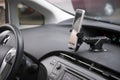 Cellphone attached by holder to the car dashboard