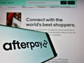 Cellphone with business logo of Australian fintech company Afterpay Limited on screen in front of website.