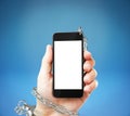 Cellphone cuffed to hand Royalty Free Stock Photo