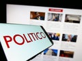 Cellphone with logo of American political newspaper company Politico LLC on screen in front of website. Royalty Free Stock Photo