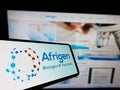 Cellphone with logo of biotechnology company Afrigen Biologics Pty. Ltd. on screen in front of website.