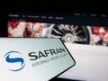 Cellphone with logo of French aerospace company Safran S.A. on screen in front of business website. Royalty Free Stock Photo