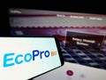Cellphone with logo of South Korean company Ecopro BM Co. Ltd. on screen in front of business website.