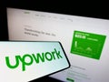 Cellphone with logo of US freelancing platform company Upwork Global Inc. on screen in front of website. Royalty Free Stock Photo