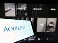 Cellphone with logo of US private equity firm Aquiline Capital Partners LLC on screen in front of business website. Royalty Free Stock Photo