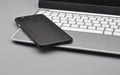 Cellphone Smartphone sitting on Laptop Notebook Netbook on a Desk Royalty Free Stock Photo