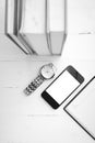 Cellphone with stack of book and watch black and white tone colo Royalty Free Stock Photo