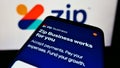 Cellphone with web page of Australian fintech company Zip Co Limited on screen in front of business logo.