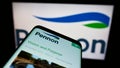 Cellphone with website of British water utility company Pennon Group plc on screen in front of business logo.