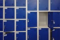 Cells in a blue color luggage storage with keys and one open door background