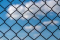 The cells of a metal lattice are against a blue sky